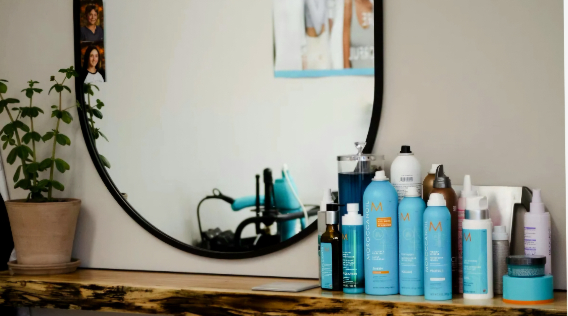 Salon styling station with hair products and mirror at 007 Style & Studio