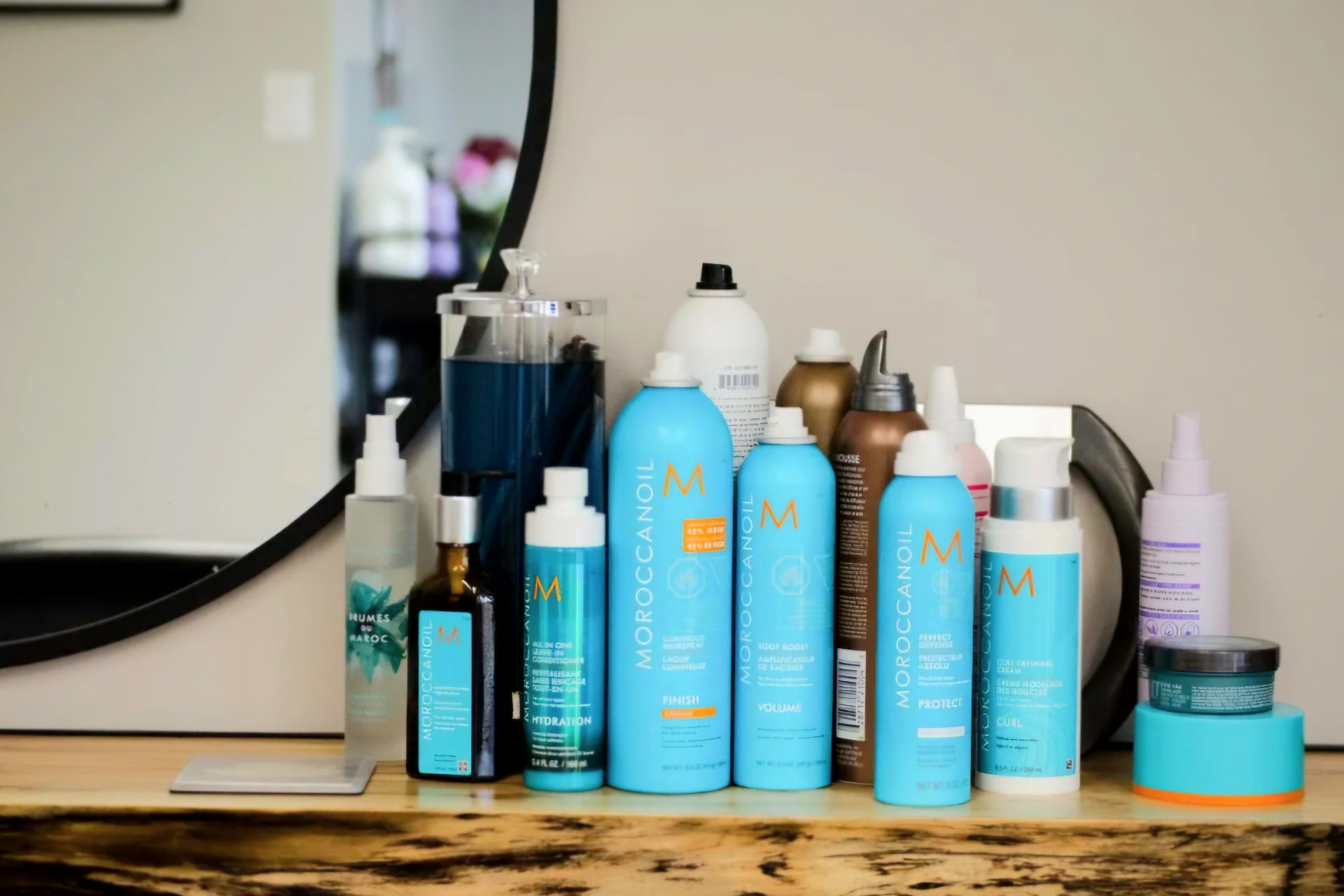 Moroccanoil product line-up on a live-edge shelf